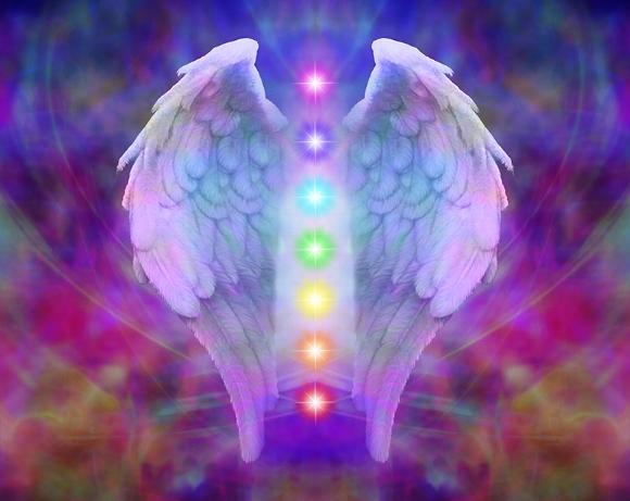 Spiritual angel wings with colorful chakras on a vibrant background
